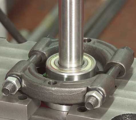 Extract the front bearing using a press or mallet